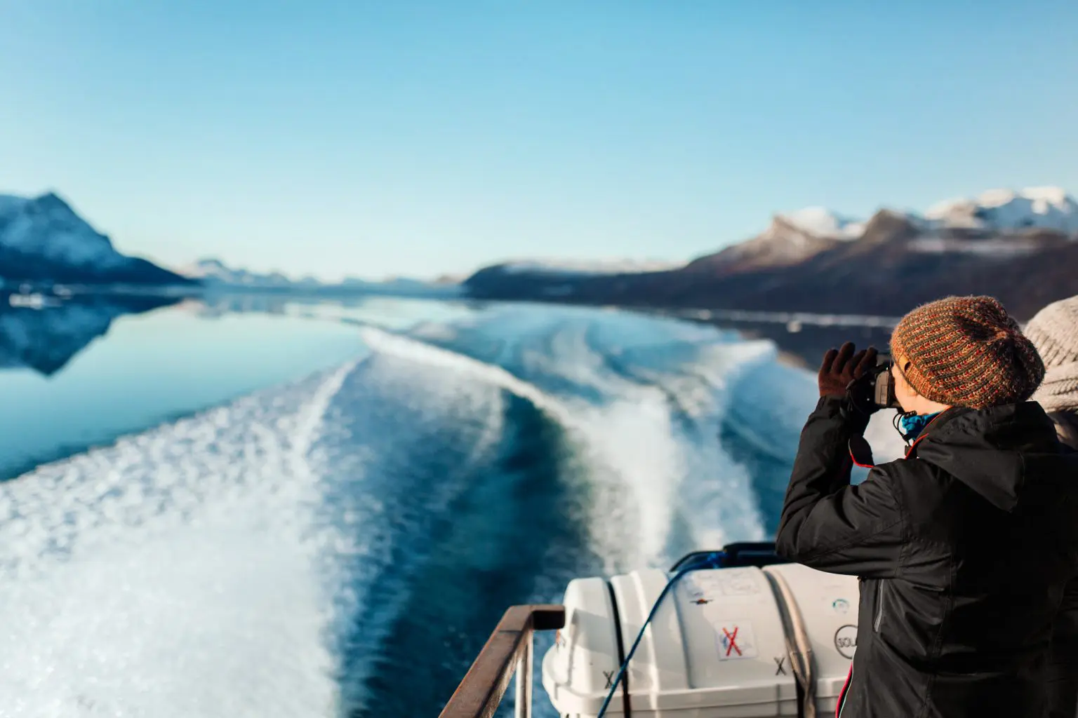 a photographer on a ship in greenland with amazing scenery